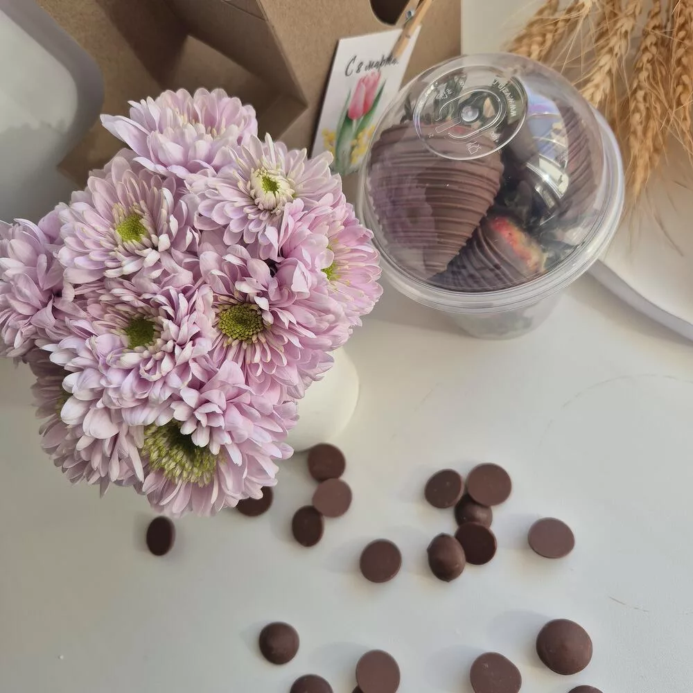 Flowers in a box with strawberries in chocolate